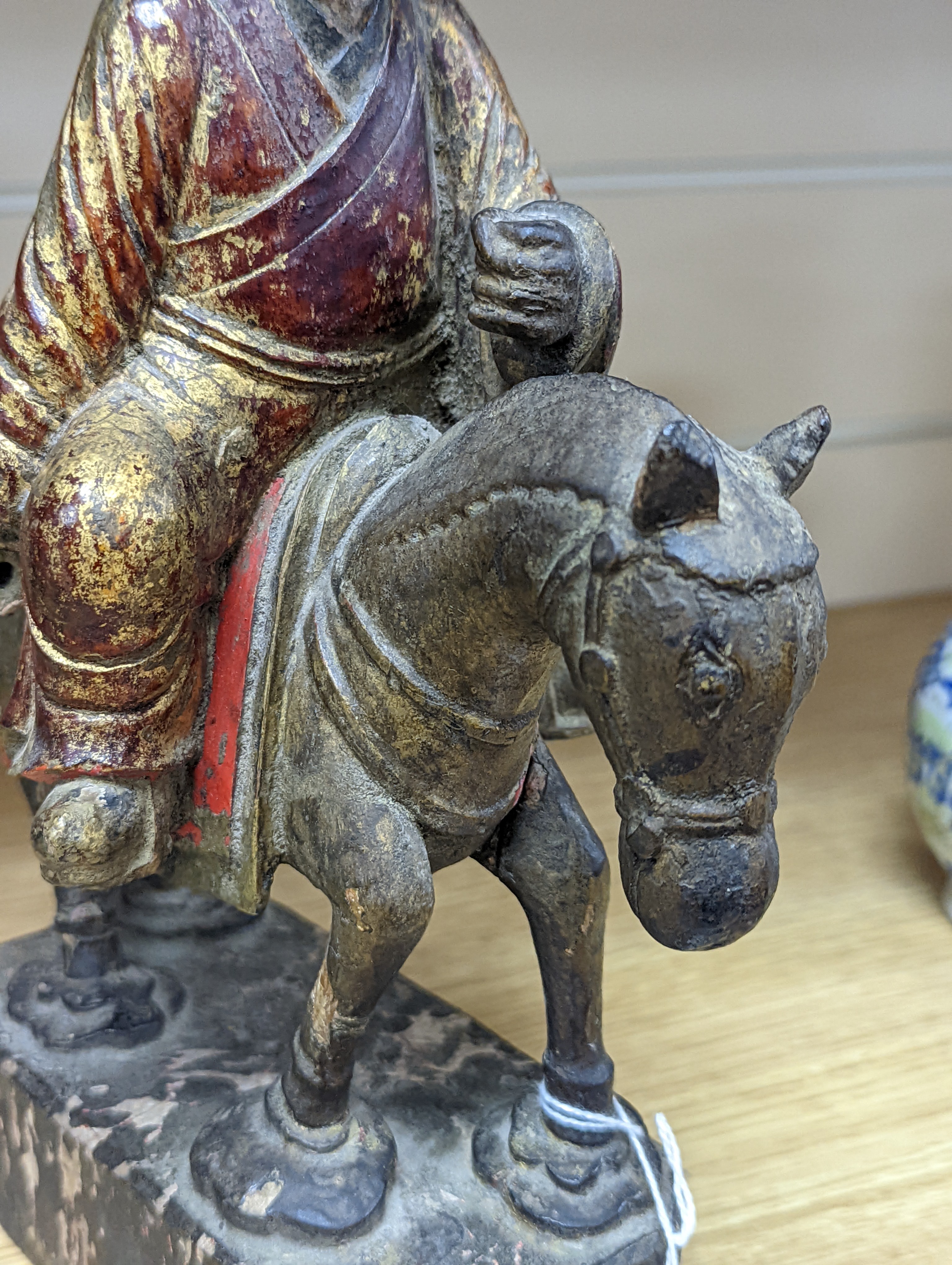 An 18th/19th century Chinese lacquered wood group of an official riding a horse, 30cm